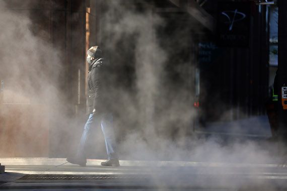 Un homme marche avec un masque au centre-ville de Toronto.